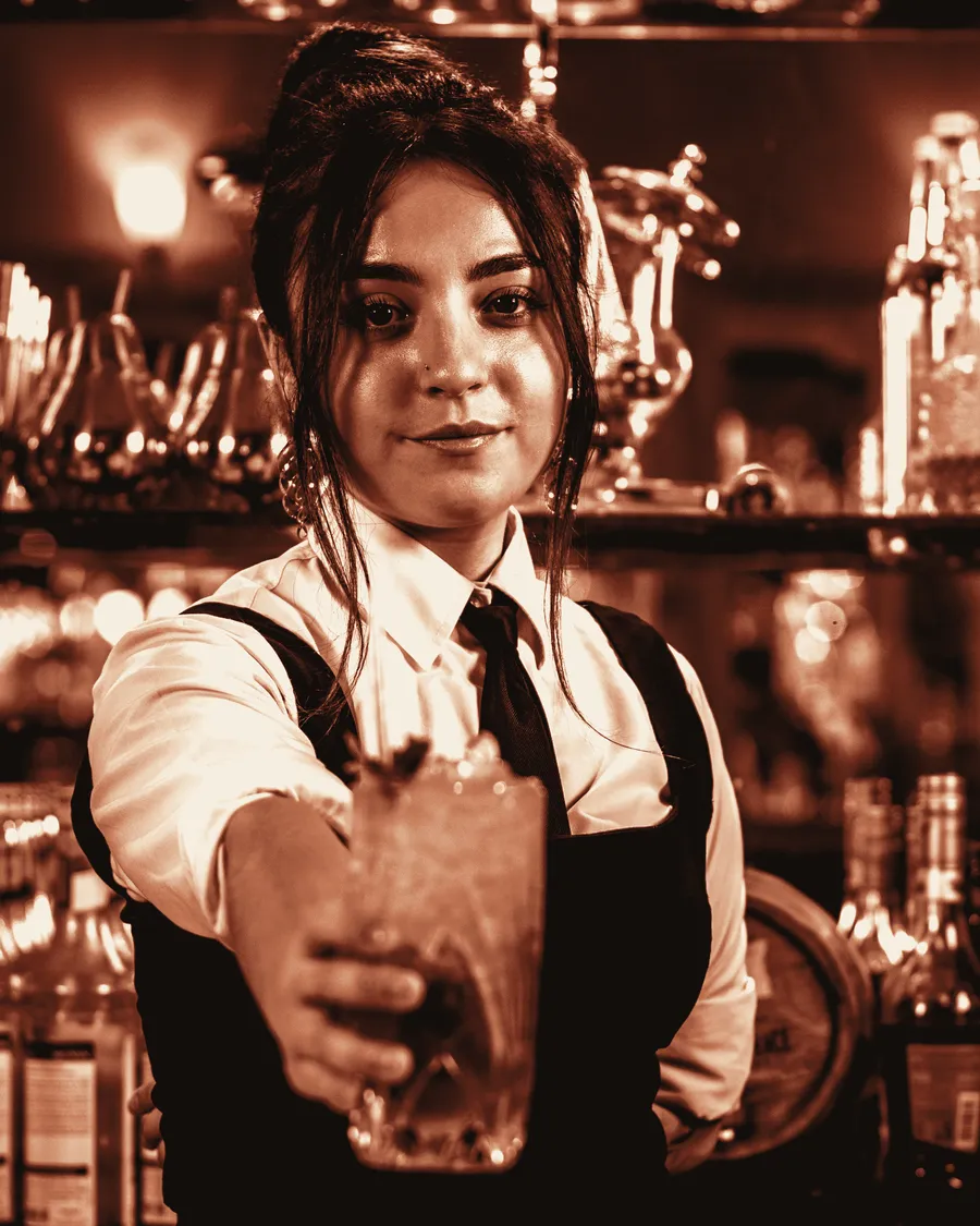 Bartender presenting a finished cocktail