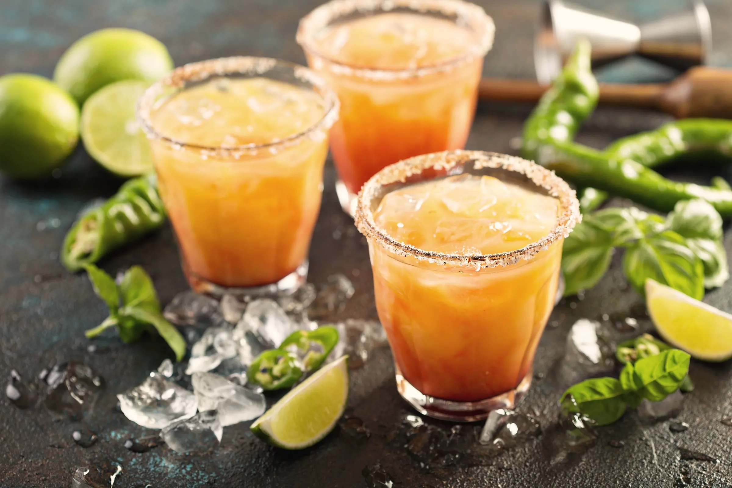 A salt-rimmed spicy margarita built with Estrato — lime, green chile, ice